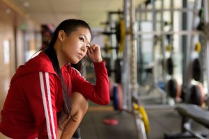 Beautiful young Asian woman ready for exercise in gym horizontal shot