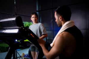 personal trainer: Asian man and woman working out, one is a trainer, the other is an exerciser